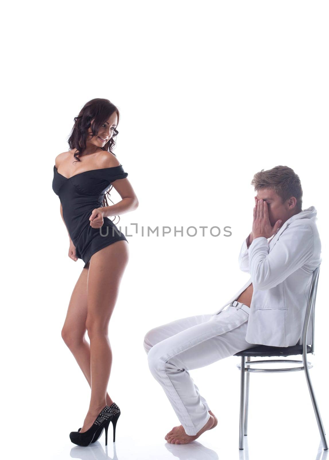 Slim playful brunette dancing for lover in studio, isolated on white
