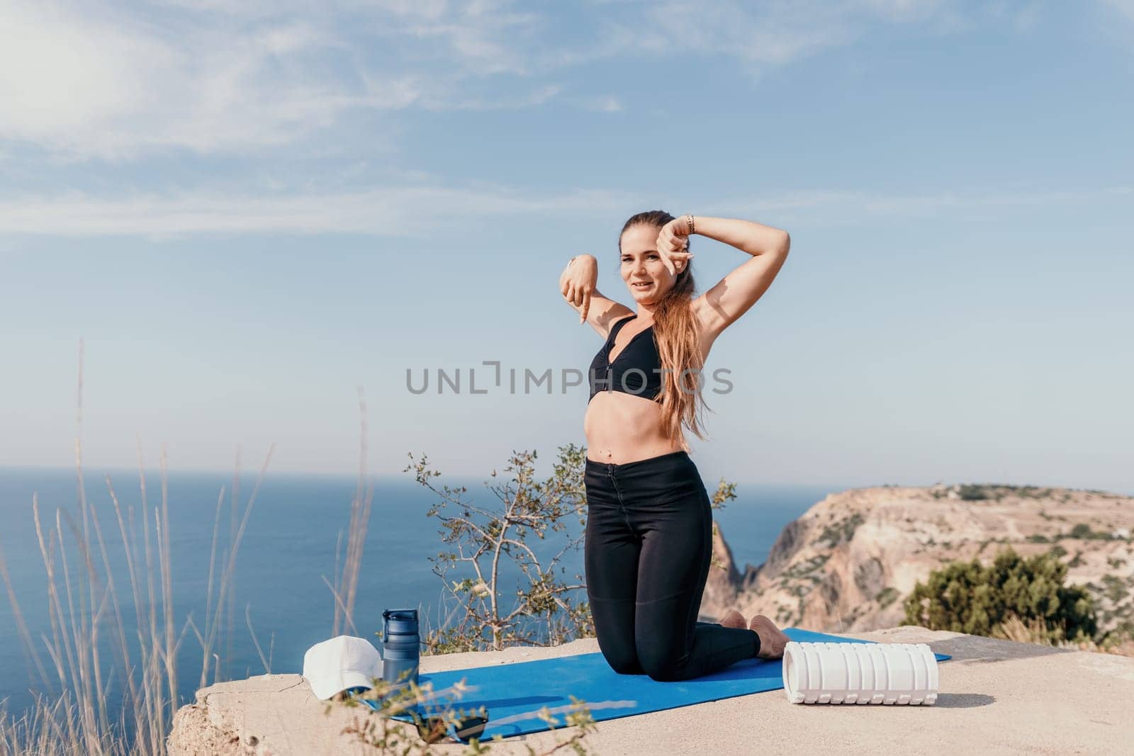 Fitness woman sea. Outdoor workout with fitness rubber bands in park over beach. Female fitness pilates yoga routine concept. Healthy lifestyle. Happy fit woman exercising with rubber band in park