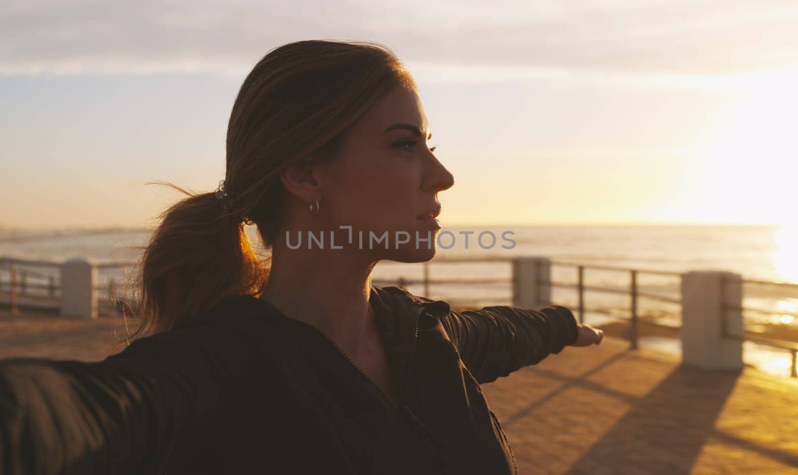 Yoga has so many benefits, mentally and physically. a woman practising yoga on the promenade