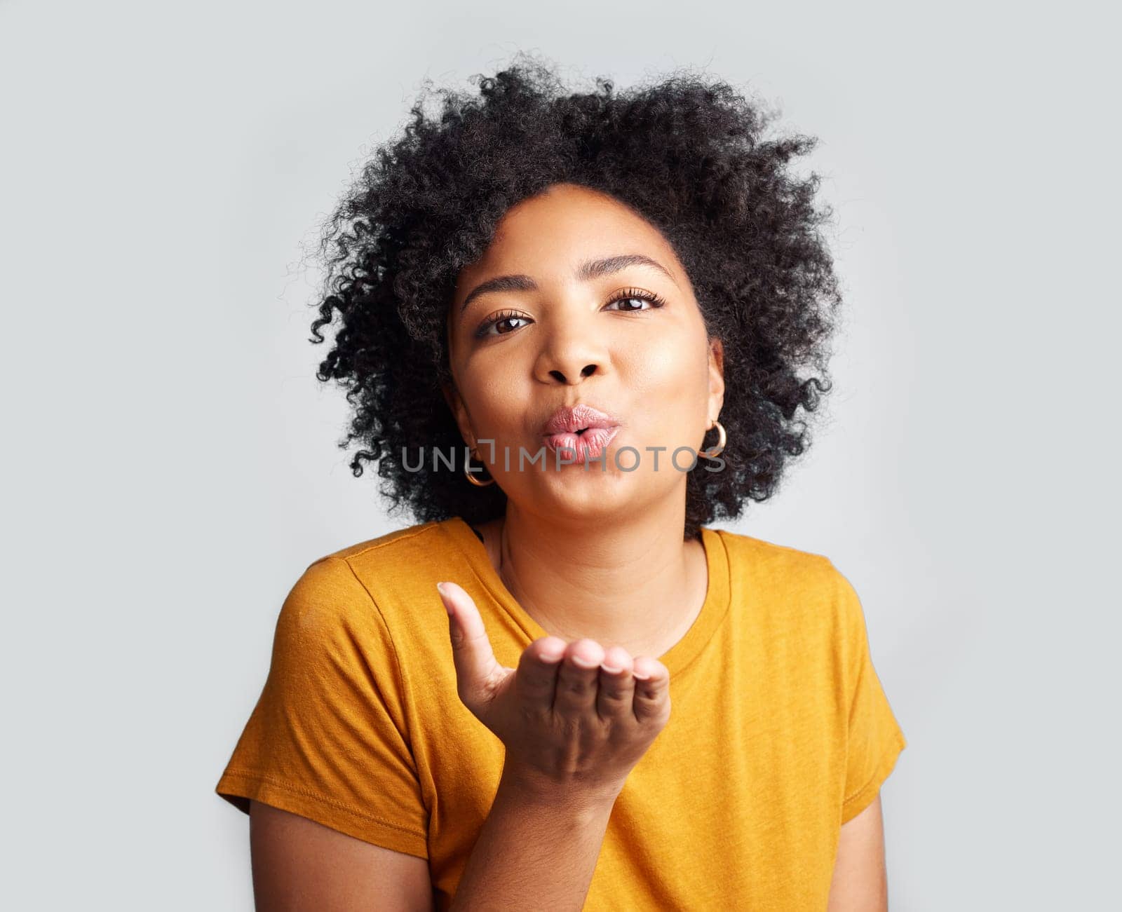 Portrait, woman and blowing kiss in white background, studio and backdrop of love, romance and flirting lips. Happy african female model, air kissing and emoji for happiness, joy and valentines day.