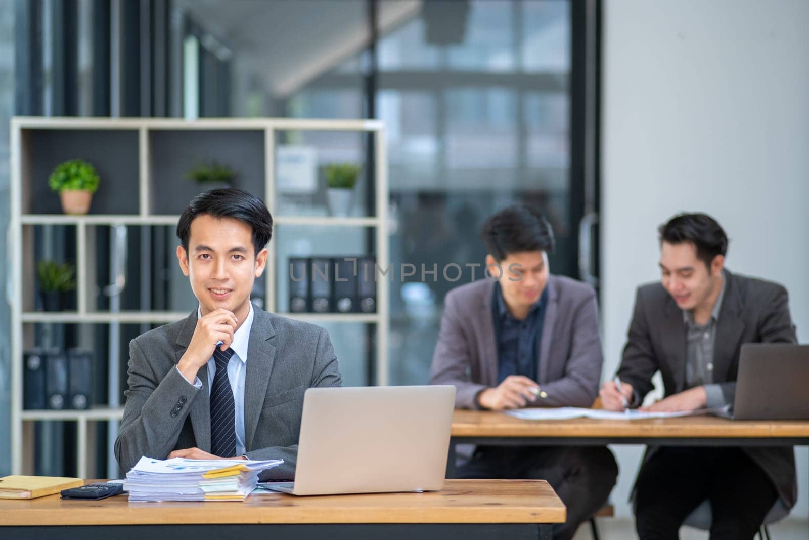 Young Professionals work in modern office, Businessman people working on computer, group of business people working together. High quality photo