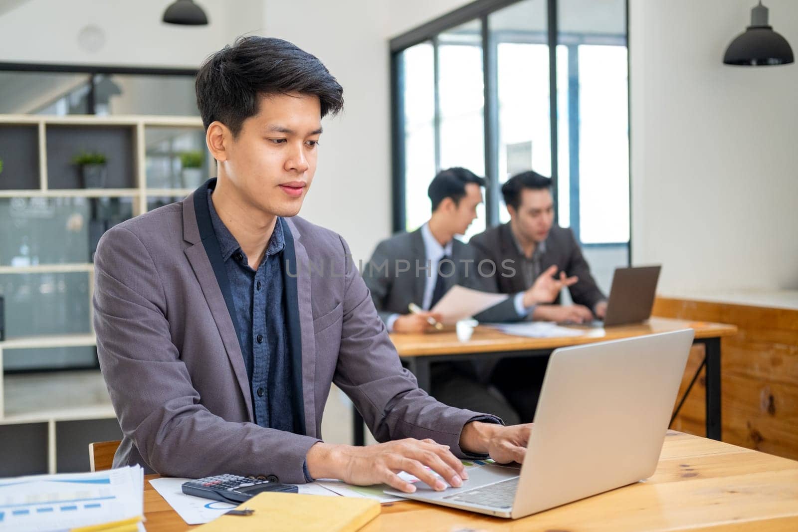 Young Professionals work in modern office, Businessman people working on computer, group of business people working together. High quality photo