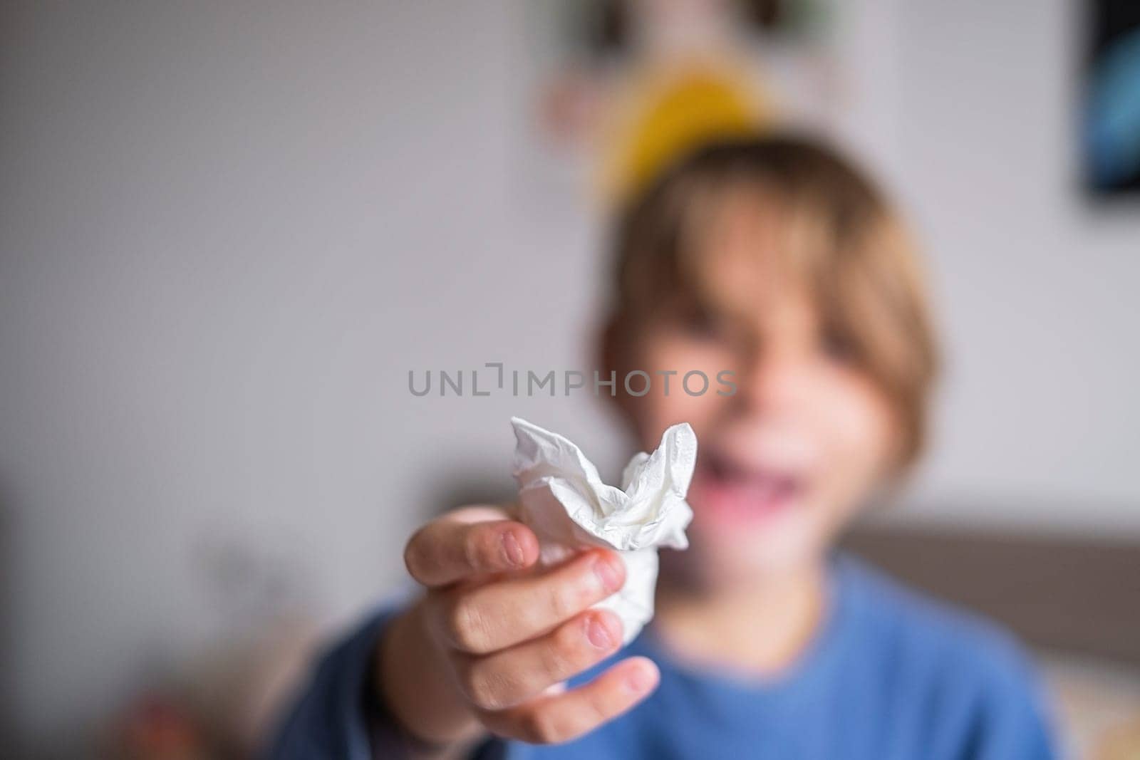 Little child boy blow his nose. Allergic kid, flu season. Kid with cold rhinitis, get cold snot nose. virus and infection