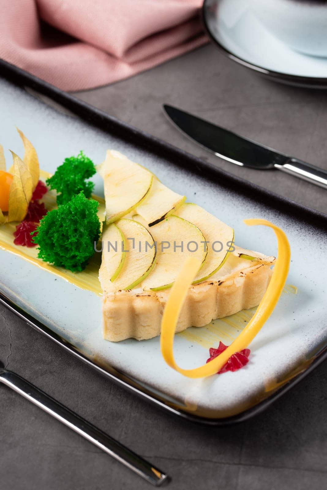 Apple tart on stone table in fine dining restaurant by Sonat