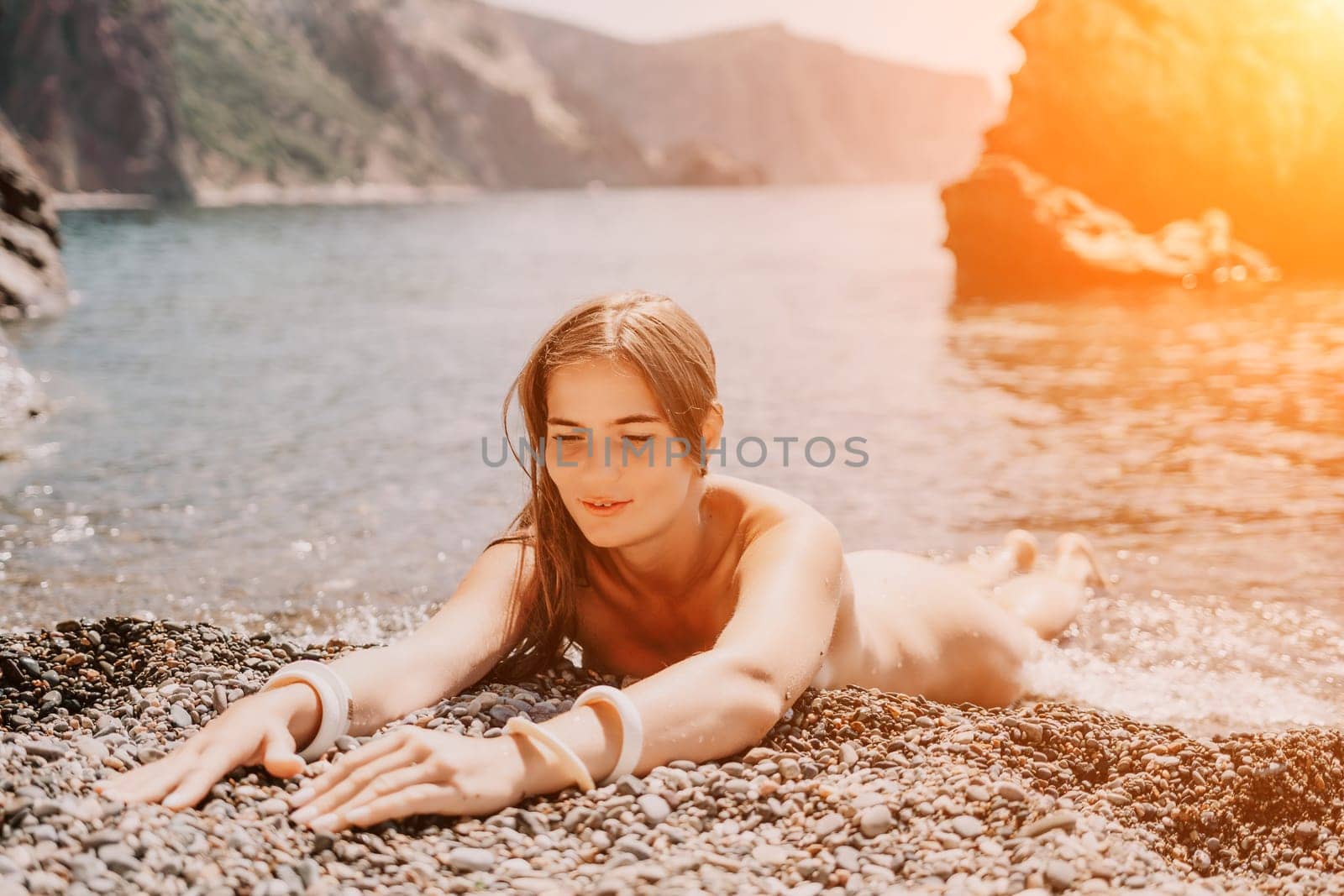 Woman travel sea. Happy tourist in hat enjoy taking picture outdoors for memories. Woman traveler posing on the beach at sea surrounded by volcanic mountains, sharing travel adventure journey by panophotograph