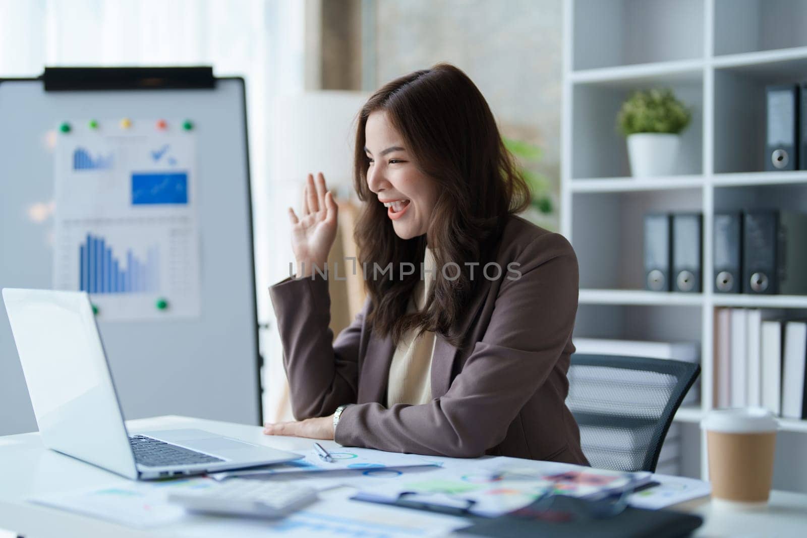 Beautiful young teen asian business woman meeting at on computer laptop with planning working on financial document, tax, exchange, accounting and Financial advisor.