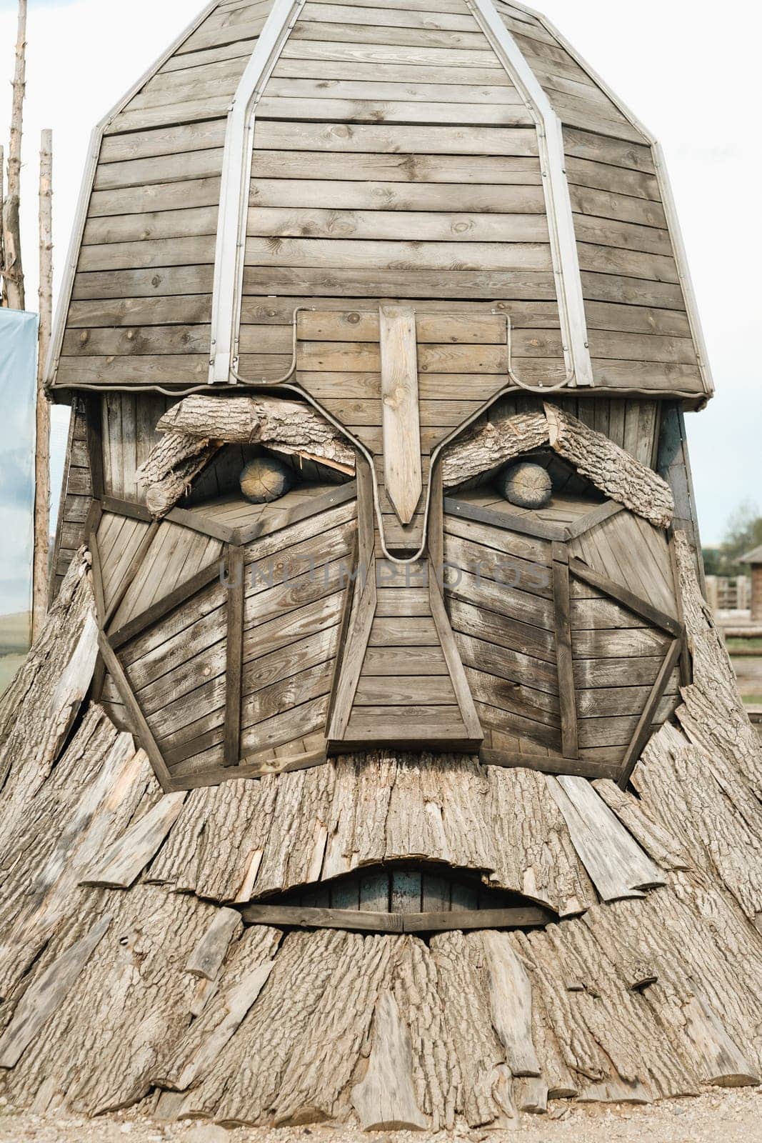 The big face of the wooden sculpture of the hero.