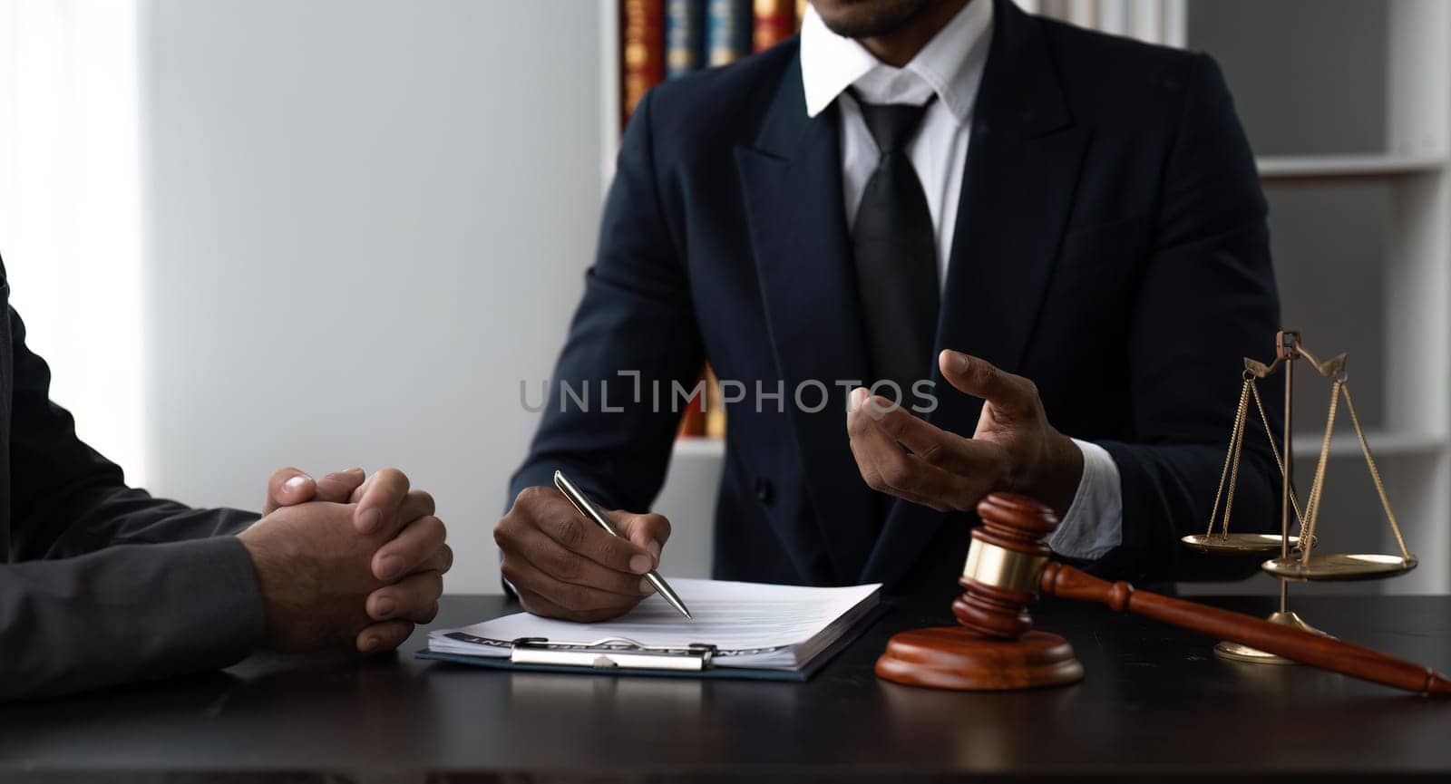 Consultation and conference of Male lawyers and businesswoman working and discussion having at law firm.