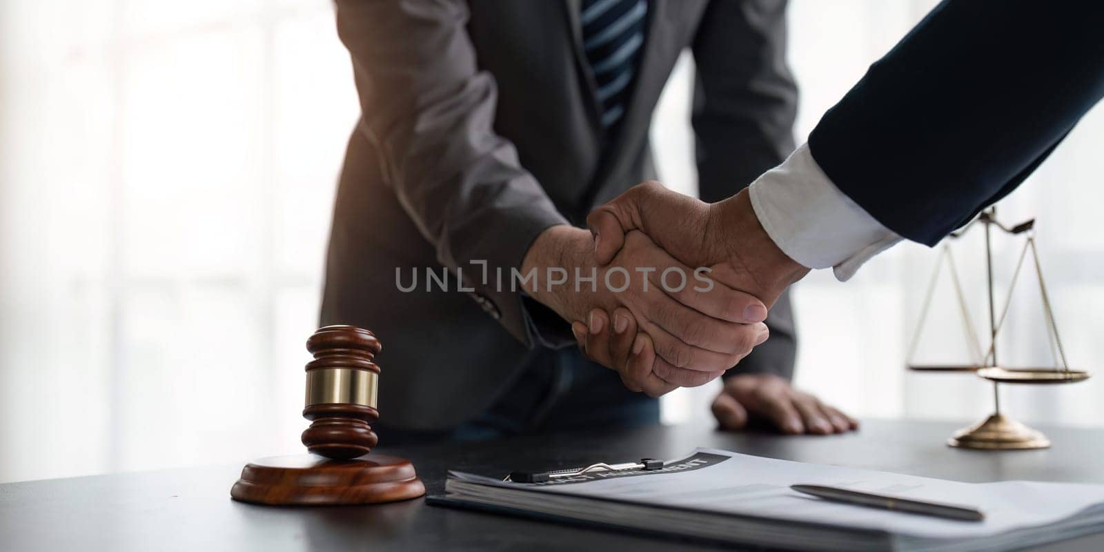 Handshake after cooperation between attorneys lawyer and clients discussing a contract agreement legal fighters, Concepts of law, advice.