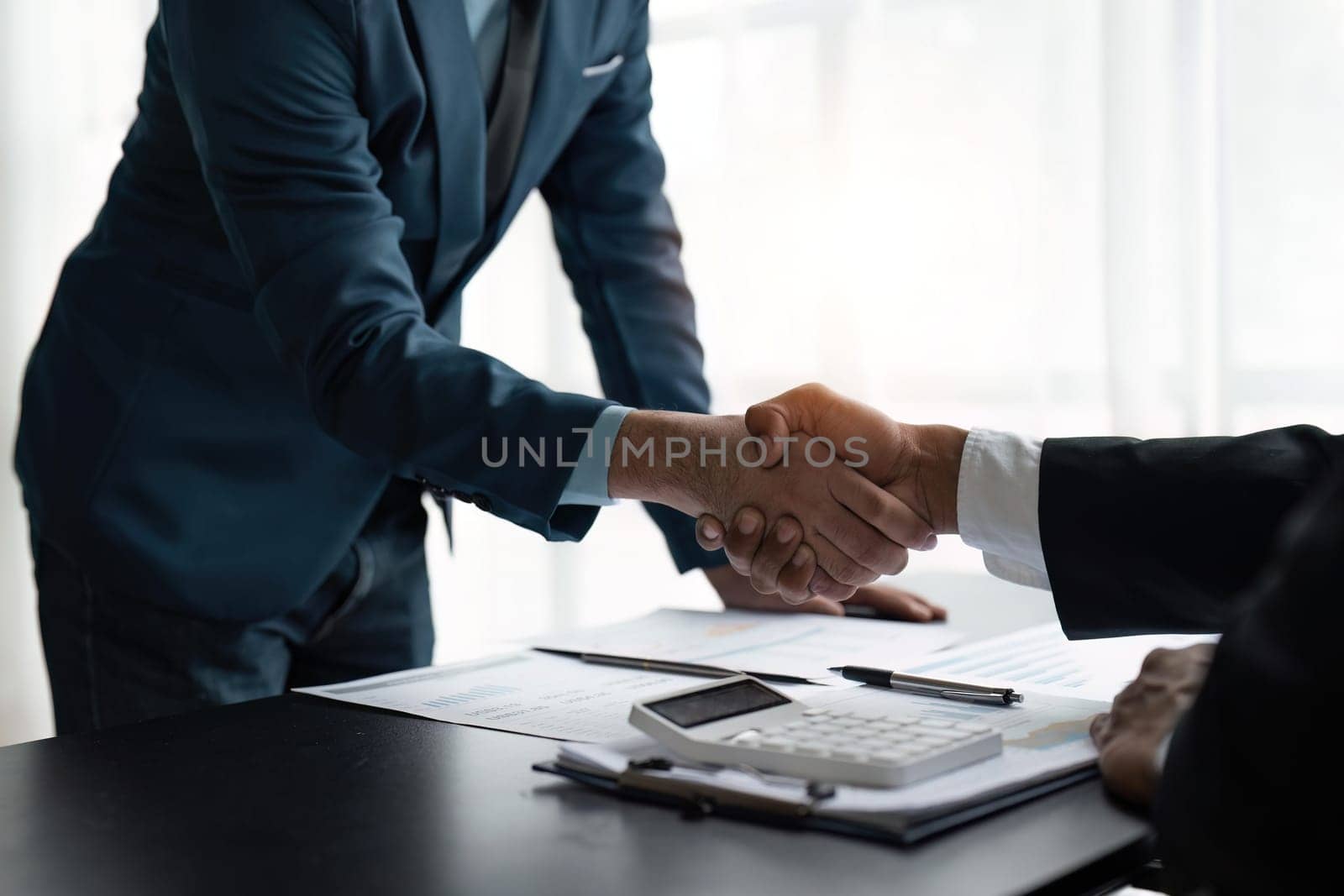 Handshake of businessmen and businessmen after meeting by nateemee