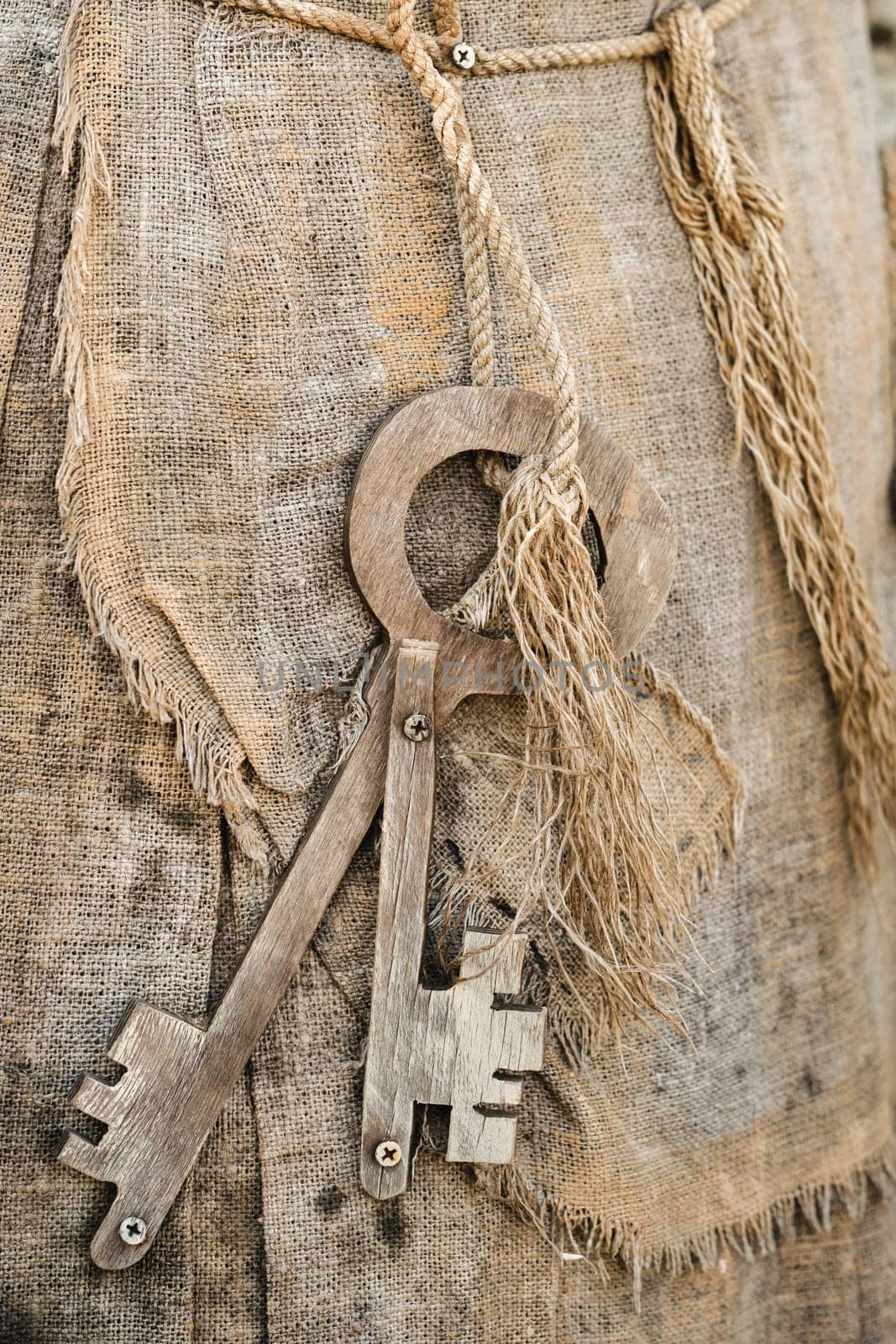 A bunch of old wooden keys hanging on a rope, close-up.