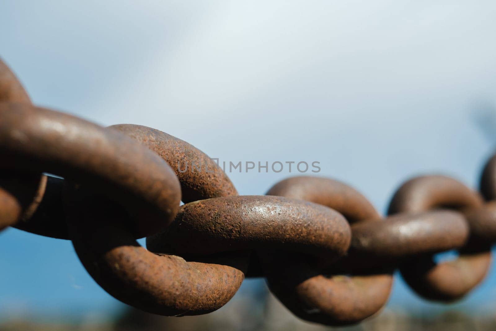 Old rusty metal chain outdoors. Large chain links.