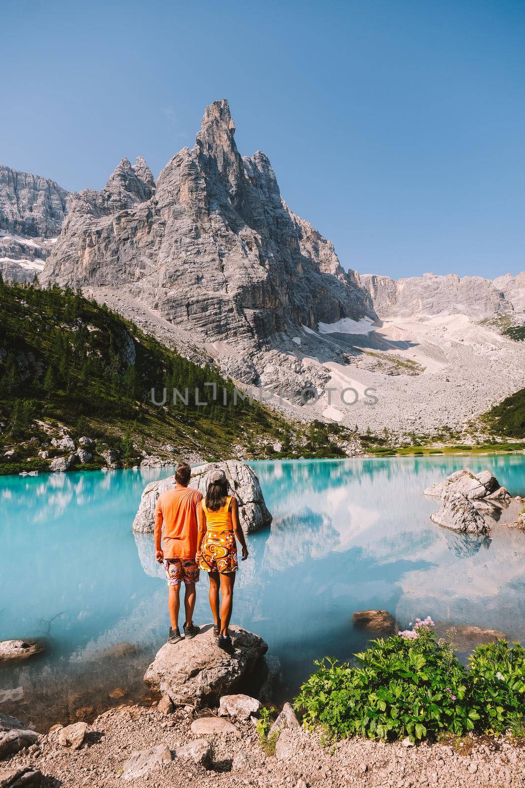 couple on vacation in the Italian Dolomites, Lago di Sorapis, Lake Sorapis, Dolomites, Italy by fokkebok
