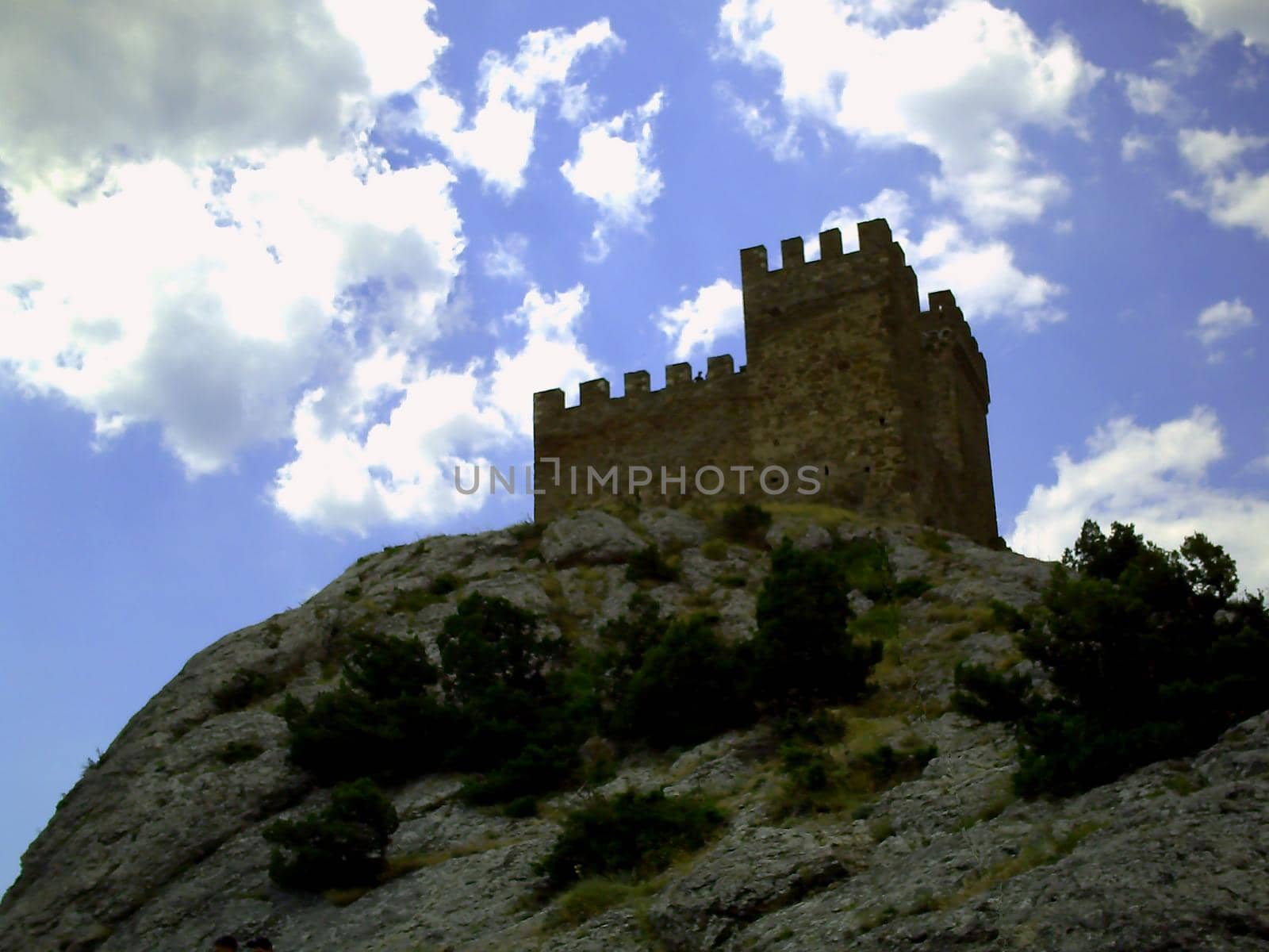 View on old stone masonry walls of Genoese fortress, Genoa fortress near Sudak, old fortress, old castle, green grass and blue sky, mountains, stones, rocks, Crimea