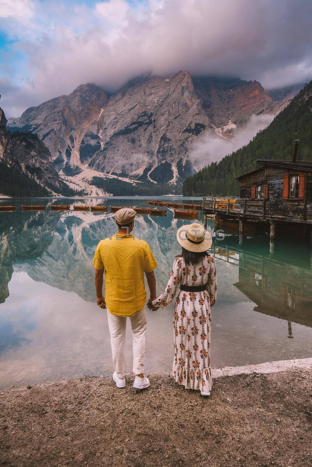 couple on vacation in the Italian Dolomites, Beautiful lake in the italian alps, Lago di Braies by fokkebok