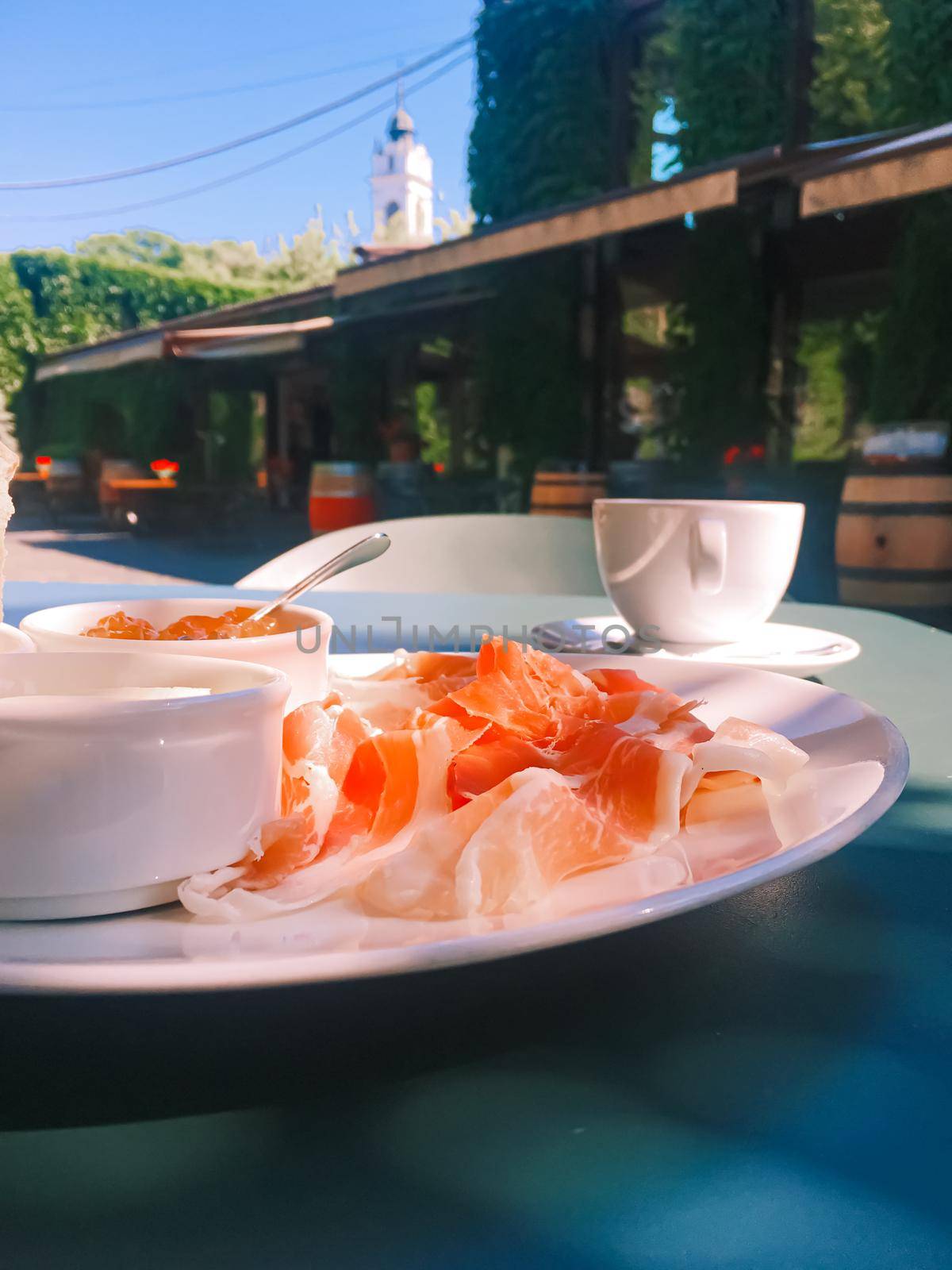 Breakfast outdoors in summer, ham, jam, butter and ham.