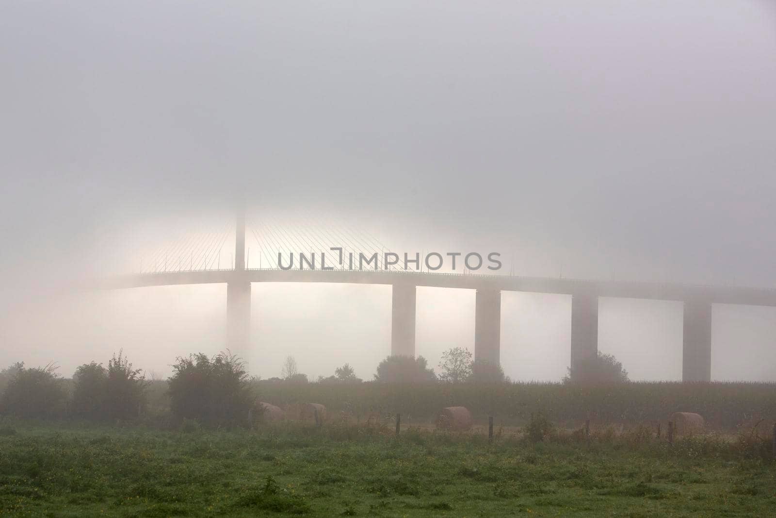 pont de brotonne over river seine in france during misty sunrise by ahavelaar