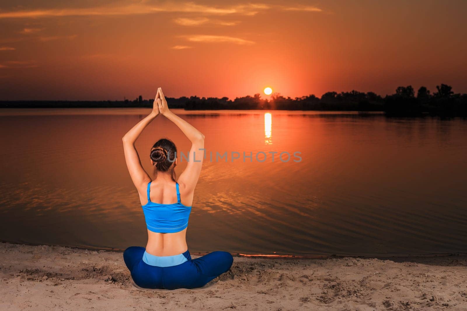 yoga at sunset on the beach. by nazarovsergey