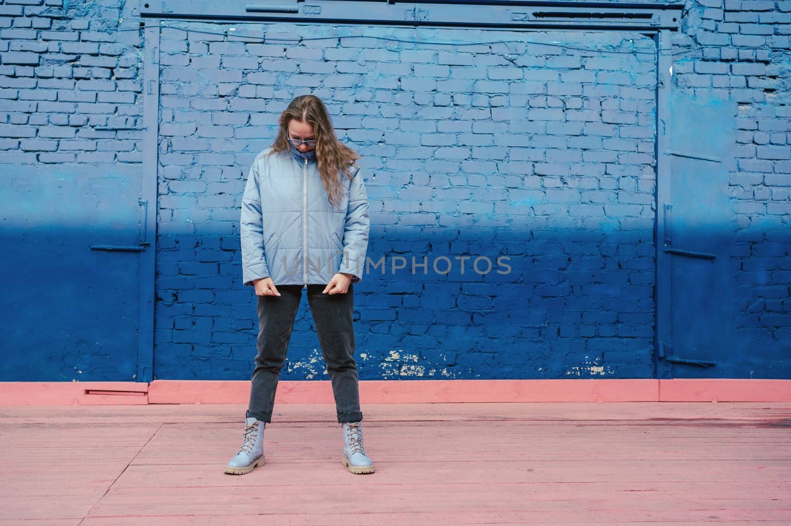 Portrait of a stylish woman in blue jacket. Spring outdoor portrait.