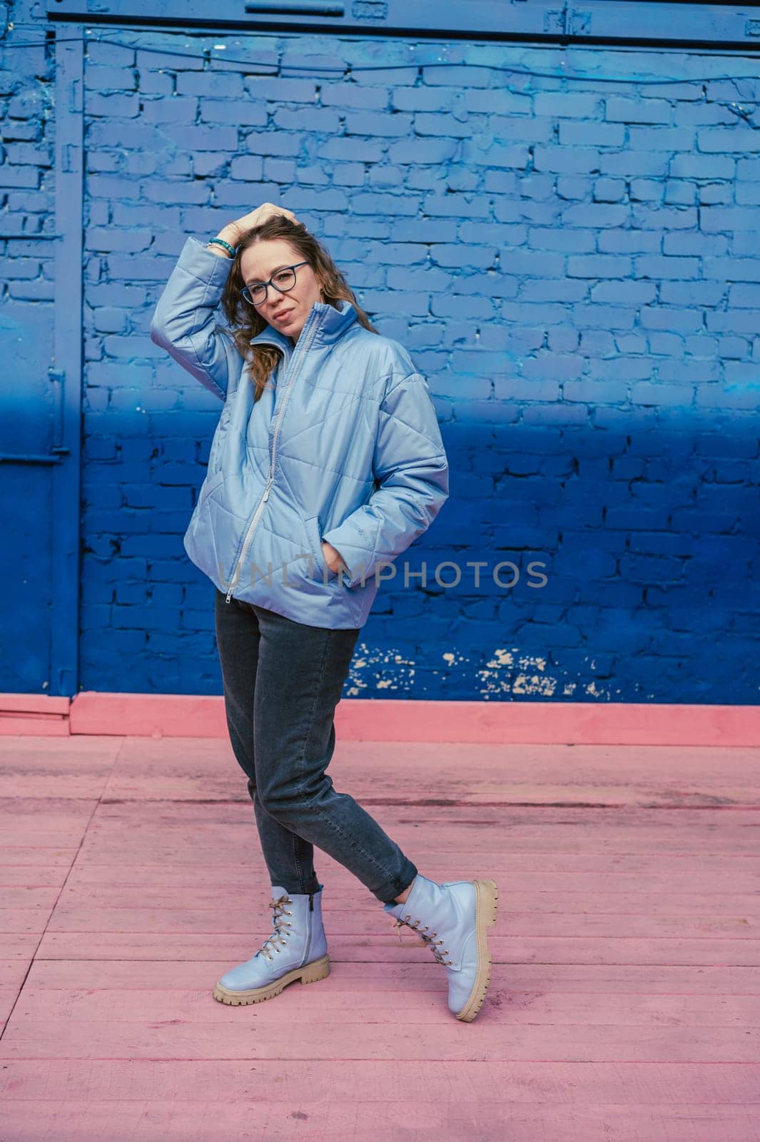 Portrait of a stylish woman in blue jacket. Spring outdoor portrait.