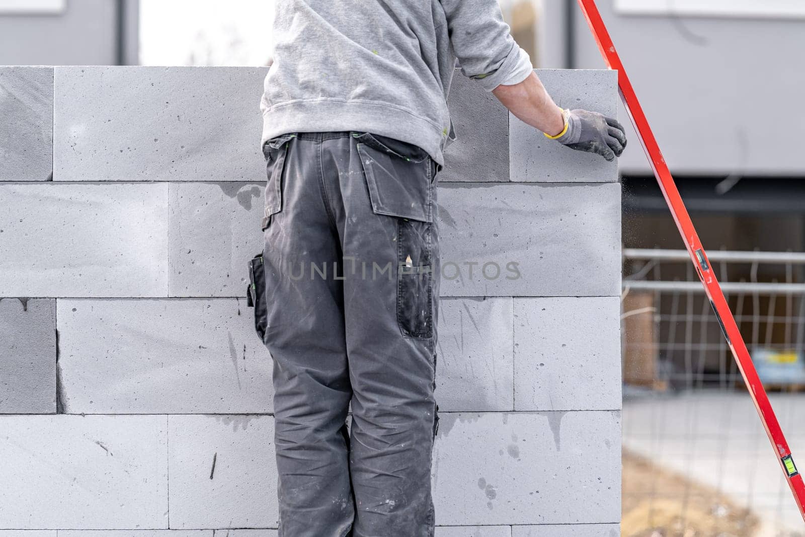 craftsman builds a house from concrete bricks. High quality photo