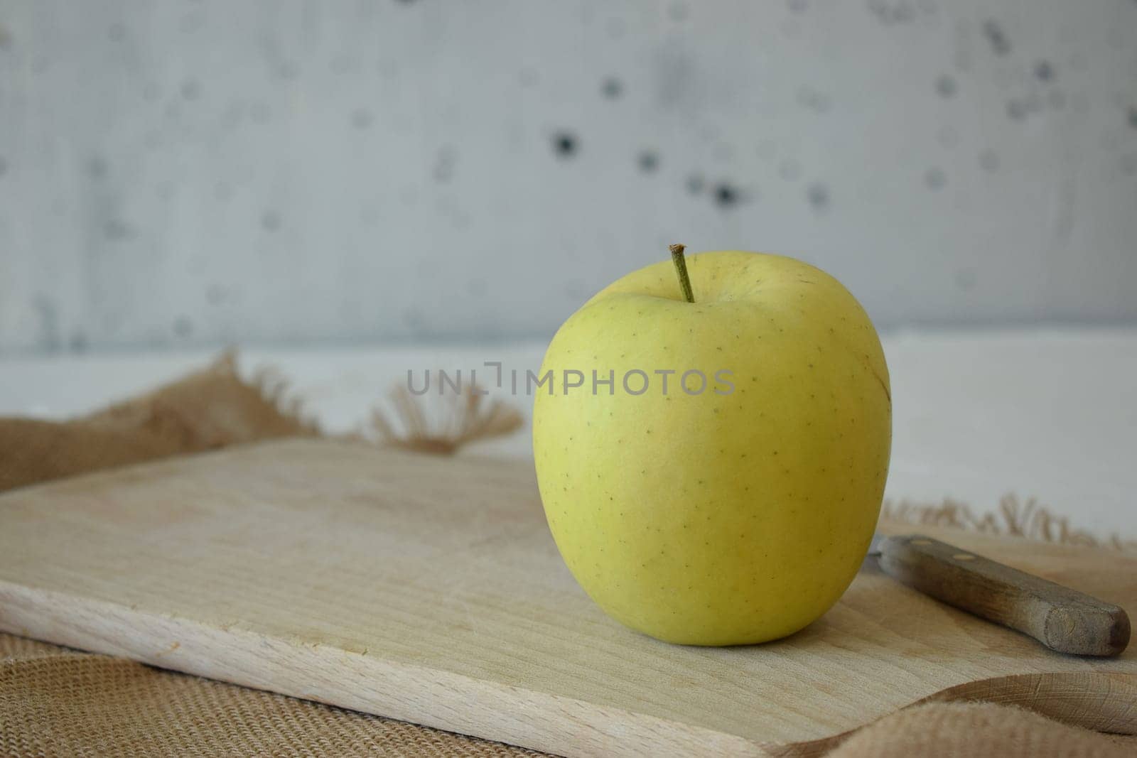 Ripe yellow apple is fresh in the kitchen.