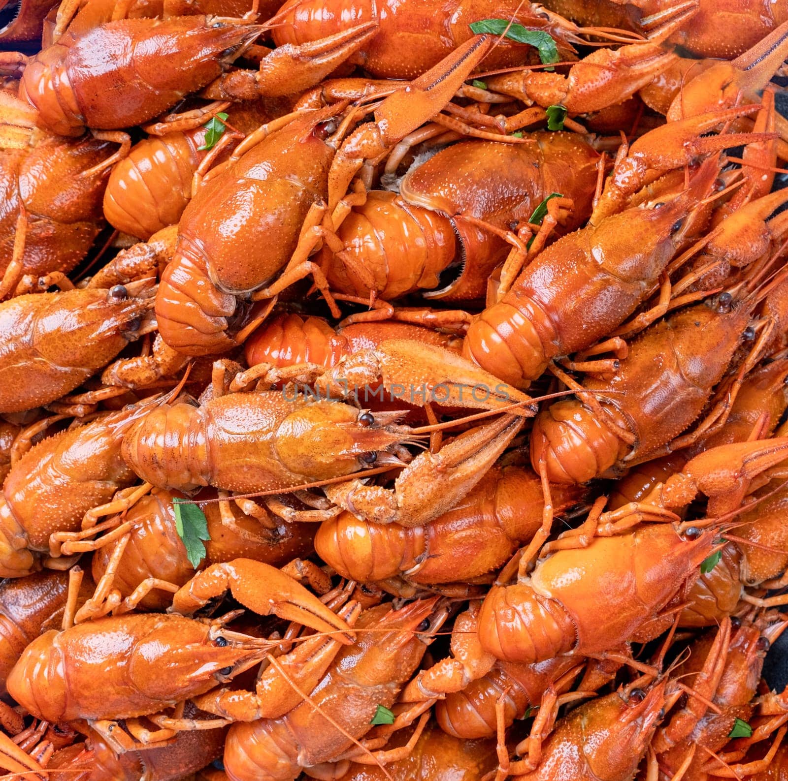 top view of cooked crawfish with lemons and spices by Desperada