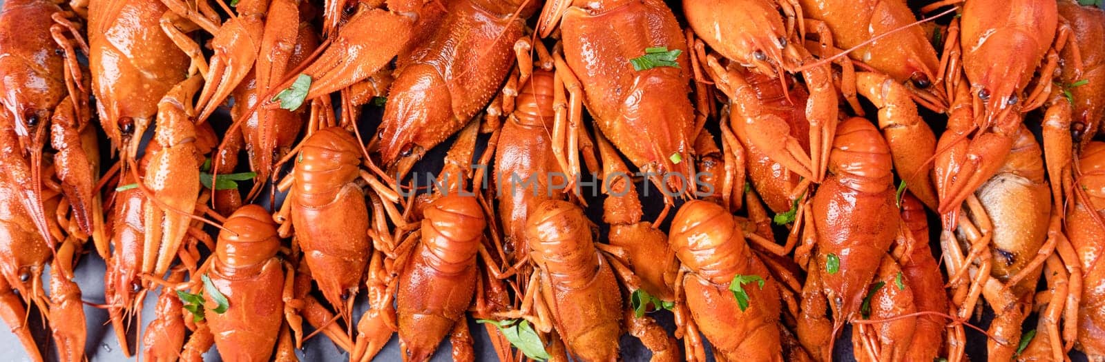 top view of cooked crawfish with lemons and spices, banner