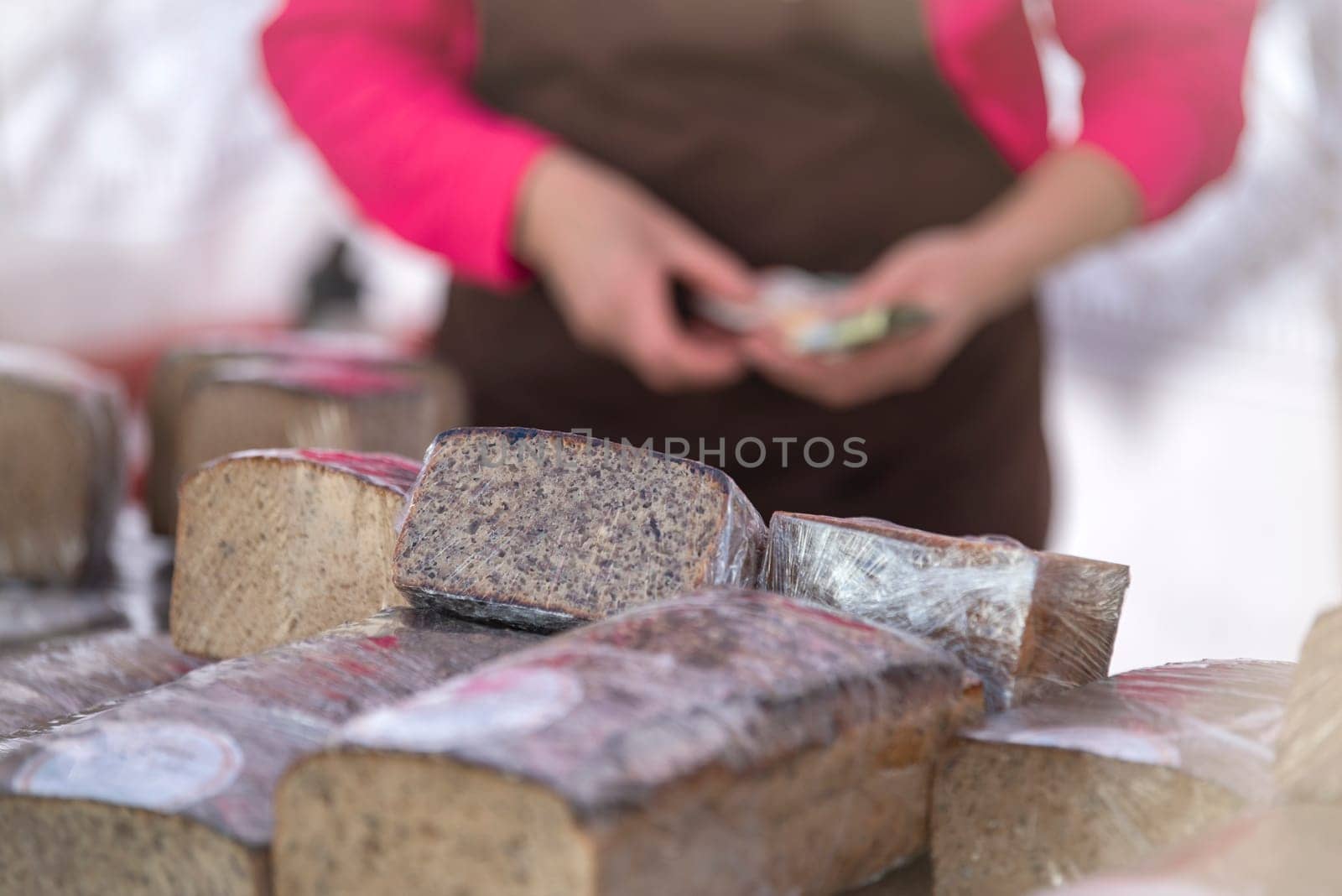 Buy bread at the store. Black and white bread on the bakery counter. Buying fresh bread, seeded black rye and hemp seeds. by SERSOL