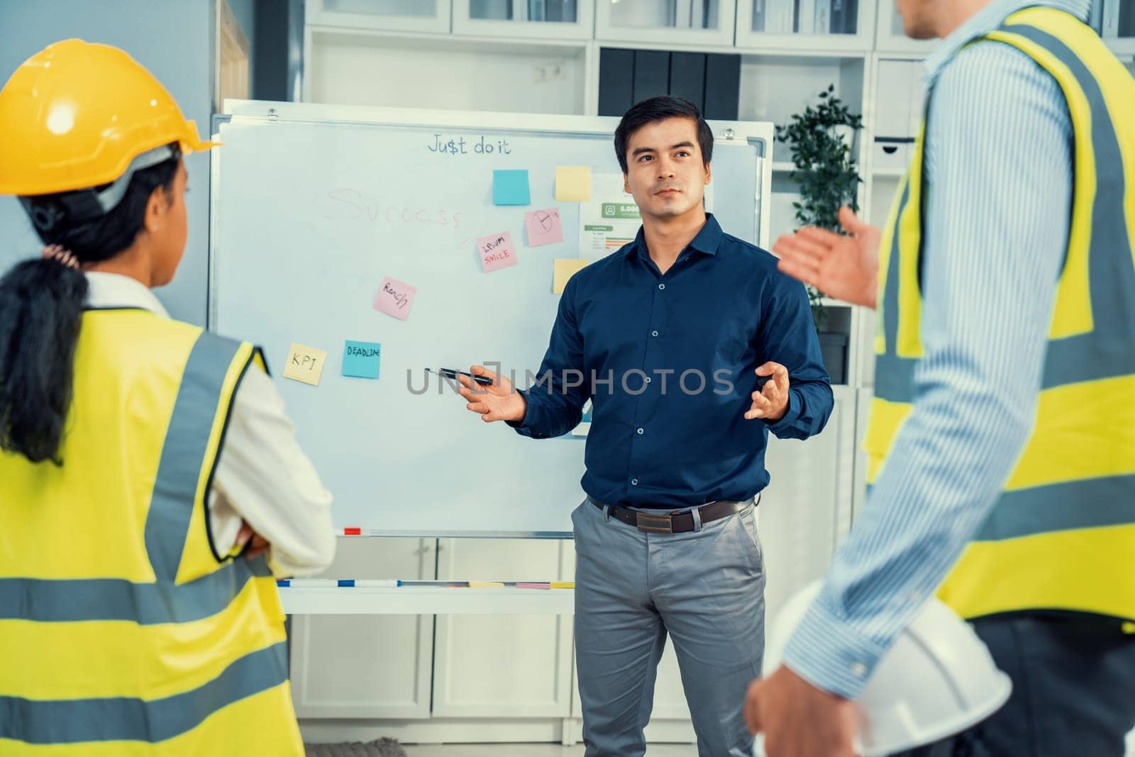 A team of investor and competent engineers brainstorming on the whiteboard to find new ideas and making plans. The idea of a team gather ideas together.