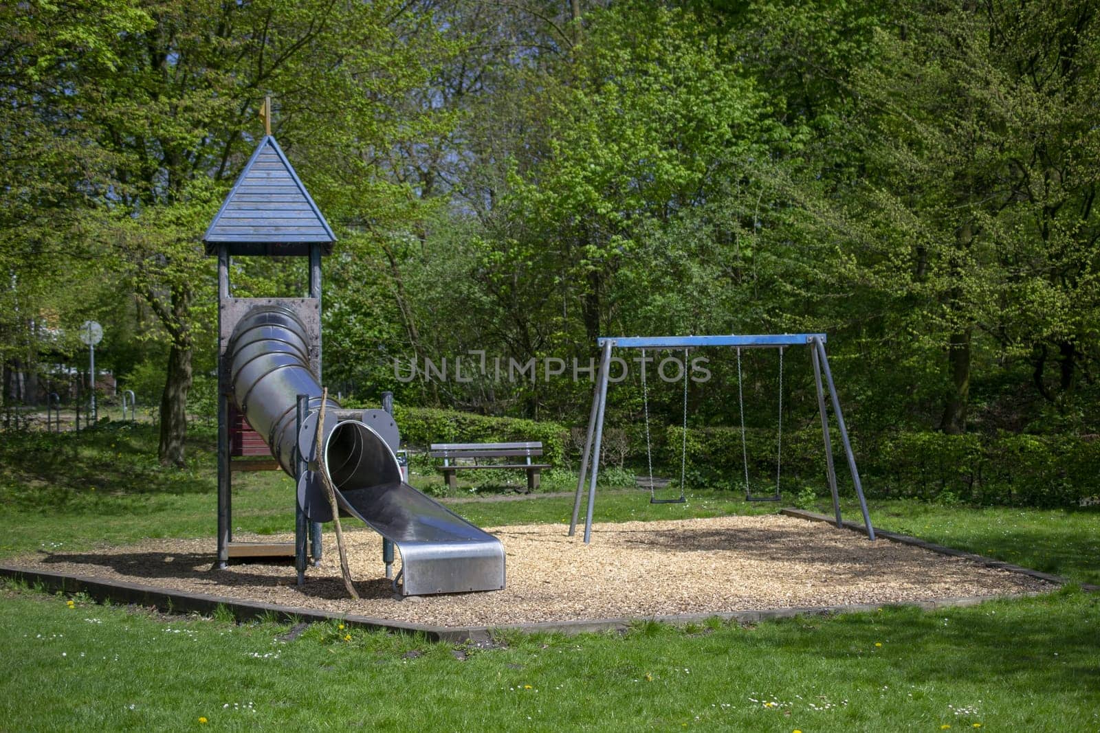 children's playground with slide at a park by Maksym