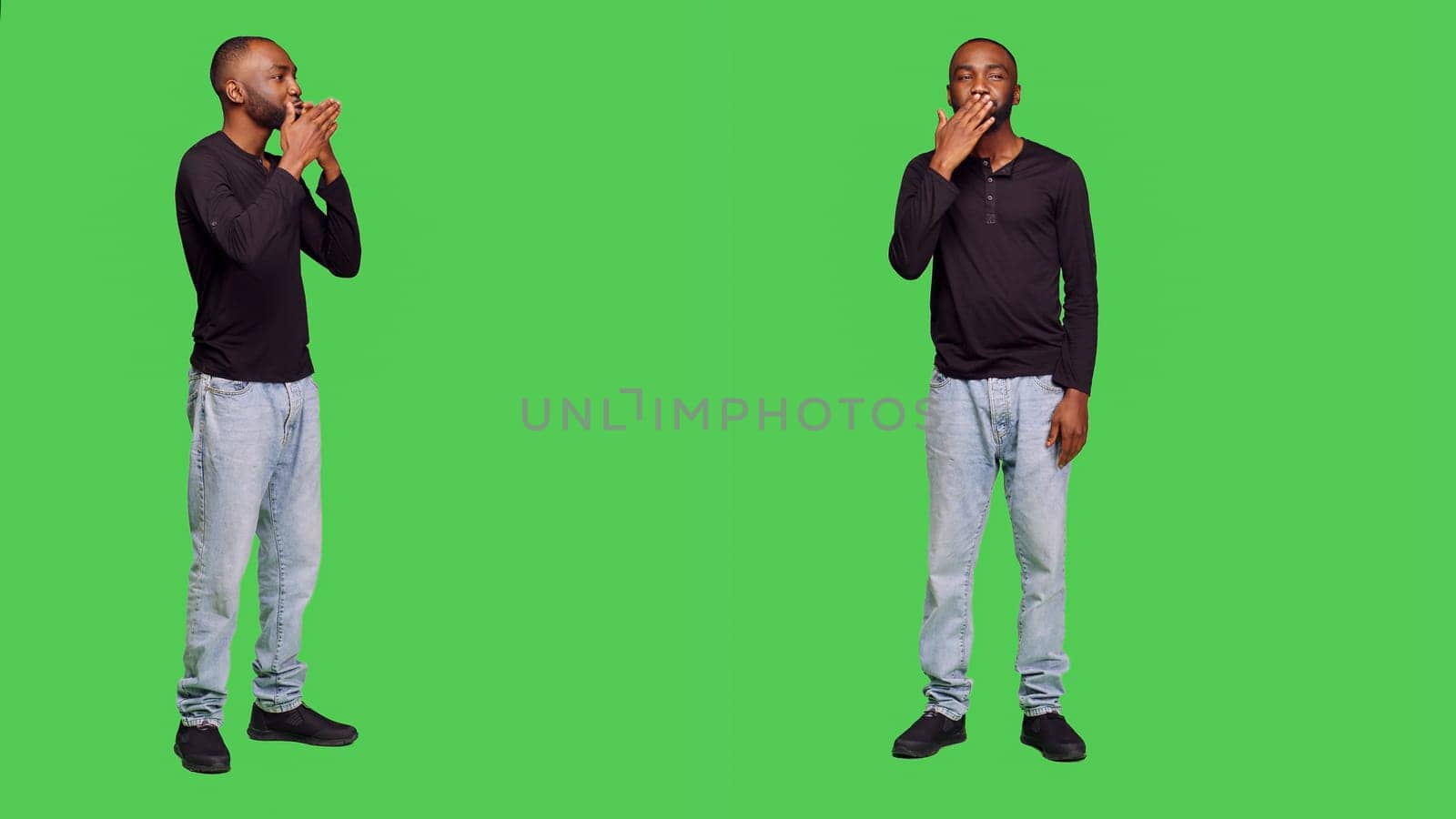 African american man sending air kisses on camera, posing with kissy face on full body greenscreen. Young adult being romantic in studio and doing flirty gesture, optimistic reaction.