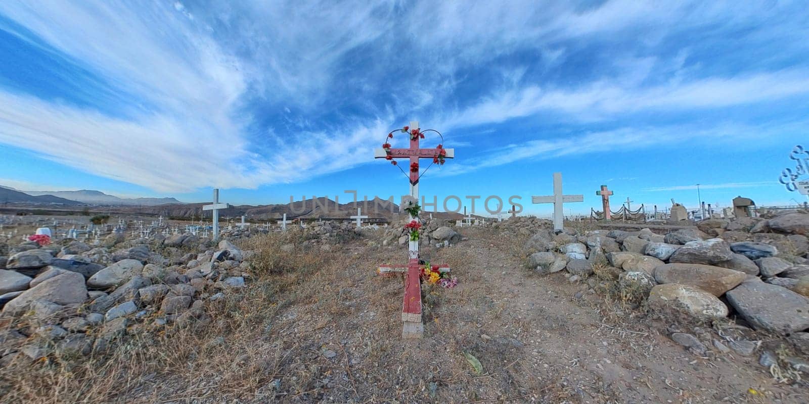 Red metal at cemetery with stripped sky background focus to soft focus