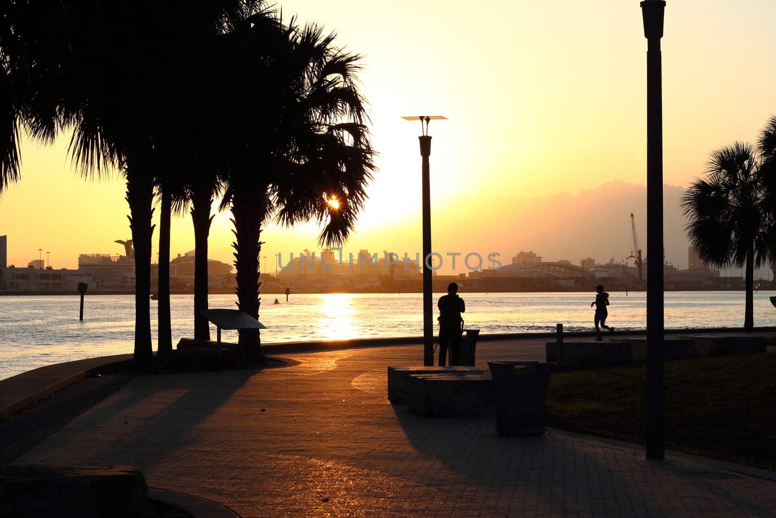 Miami Brickell - Morning run with cruise terminal in the background. Orange sunset.