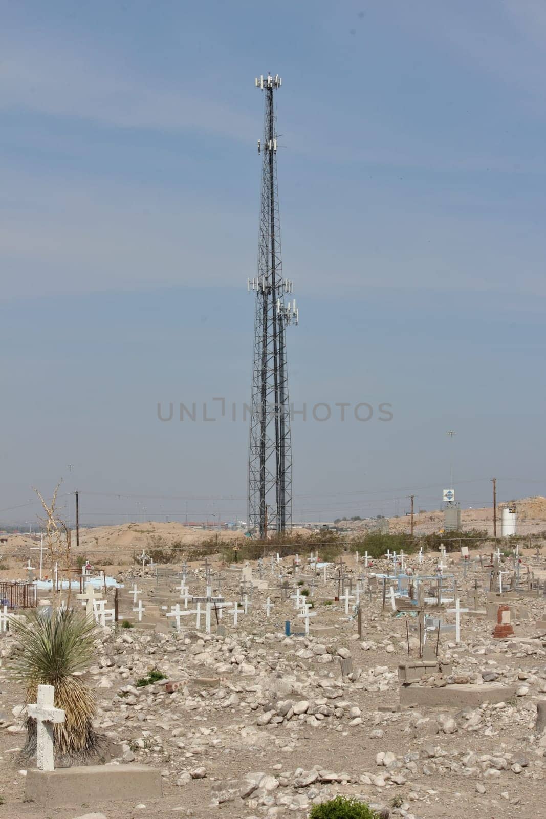 Transmission tower in the cemetery of a village, does 5G harm people.
