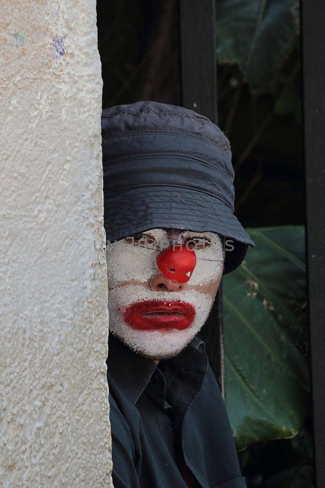 Mexico City, Mexico, October 17, 2019. A sad homeless clown looking into the camera.