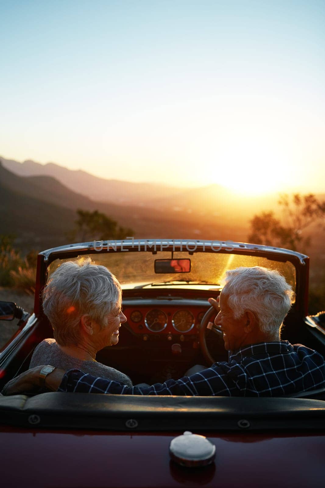 Its our time now. Weve earned it. an affectionate senior couple enjoying the sunset during a roadtrip. by YuriArcurs