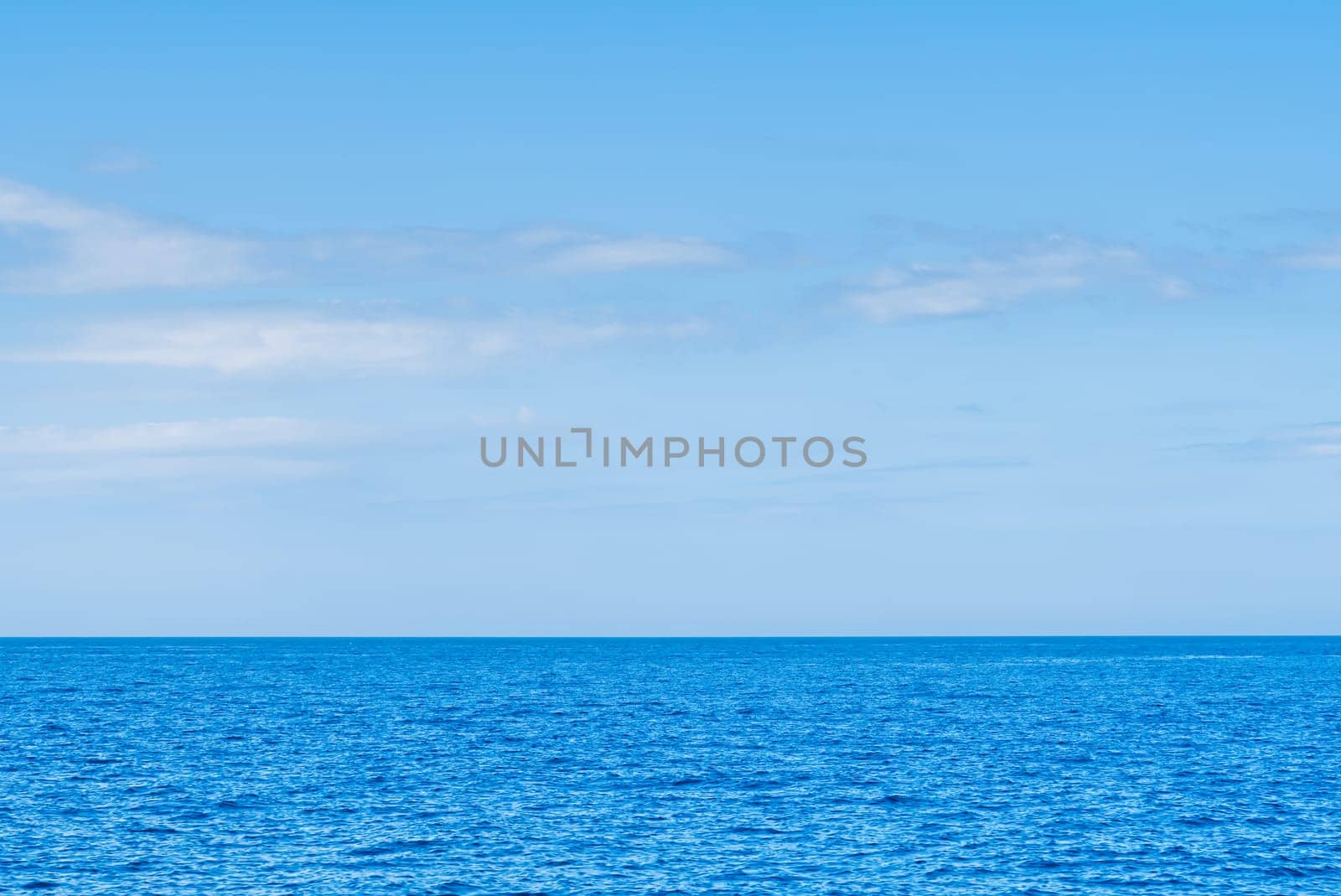 Blue sea and white clouds on sky. Water cloud horizon background. Feeling calm, cool, relaxing. The idea for cold background and copy space on the top. the ocean deep indigo