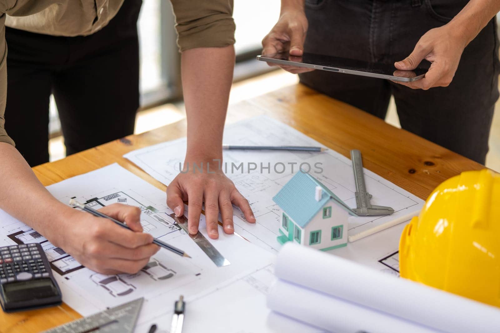 Young engineer architect sketching drawing project plan building construction, closed up cooperation corporate achievement planning design draw technology. High quality photo