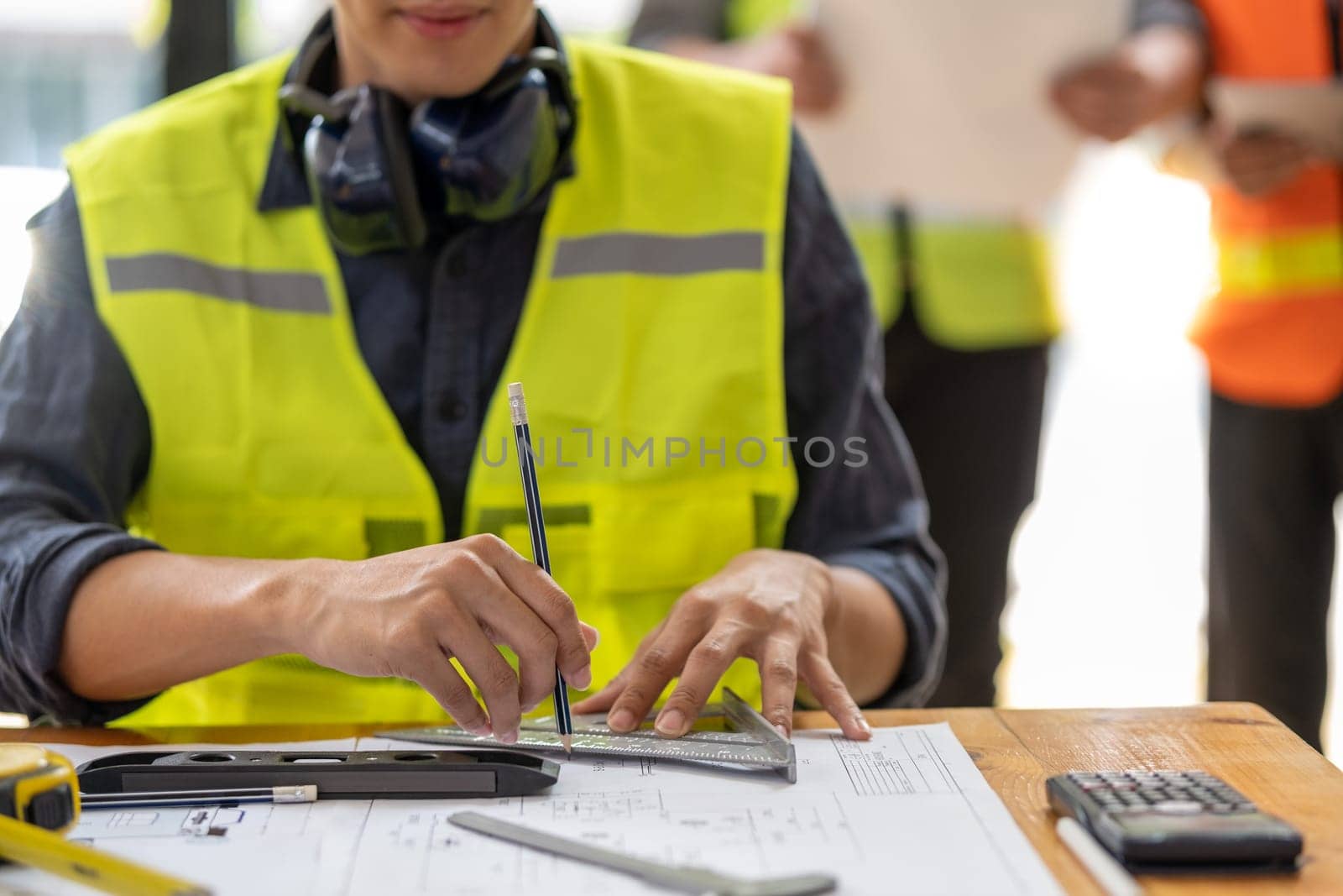 Young engineer architect sketching drawing project plan building construction, closed up cooperation corporate achievement planning design draw technology. High quality photo