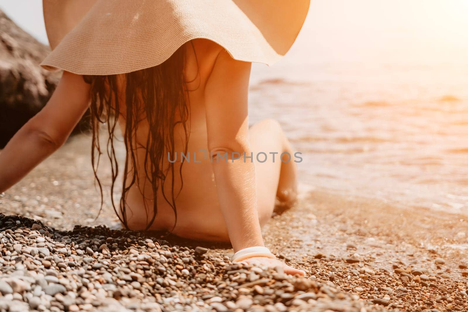 Woman travel sea. Happy tourist in hat enjoy taking picture outdoors for memories. Woman traveler posing on the beach at sea surrounded by volcanic mountains, sharing travel adventure journey by panophotograph