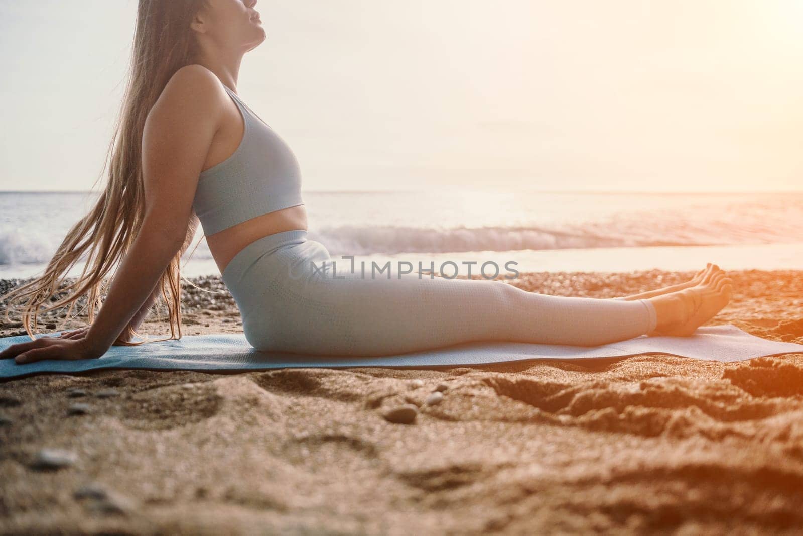 Woman sea pilates. Sporty happy middle aged woman practicing fitness on beach near sea, smiling active female training on yoga mat outside, enjoying healthy lifestyle, harmony and meditation. by panophotograph