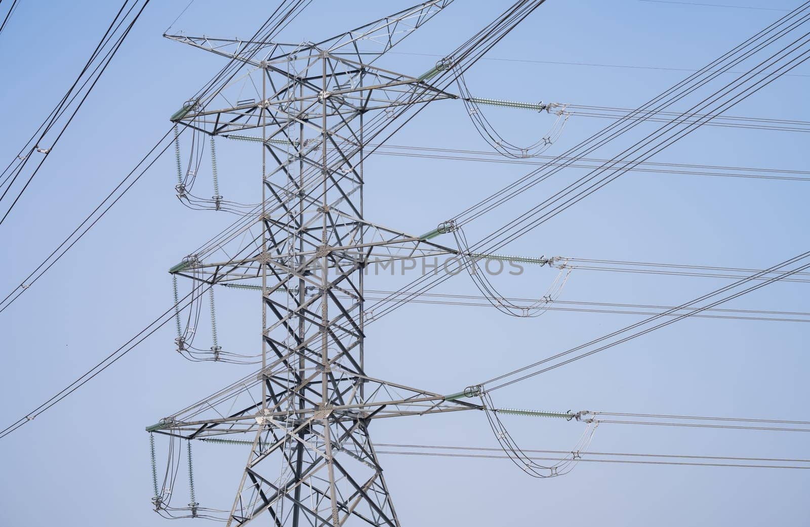 High voltage electric transmission tower. High voltage power lines against the sky. Electricity pylon and electric power transmission lines. High Voltage tower provide power supply. Energy crisis. by Fahroni