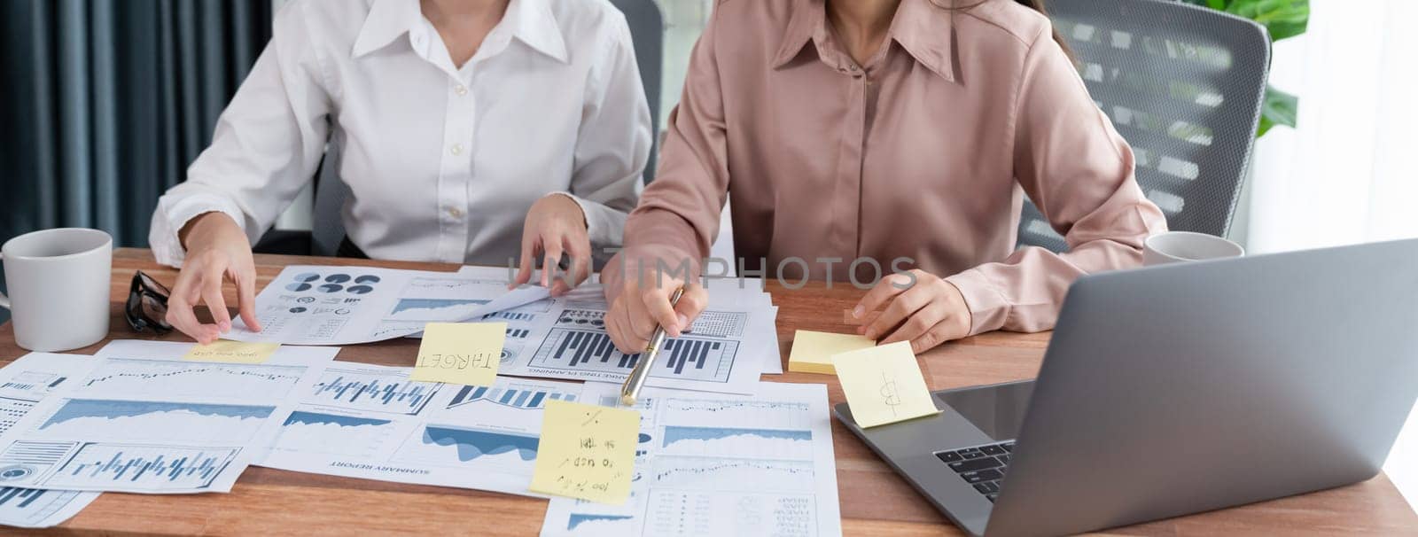 Closeup analyst team colleagues discuss financial data on digital dashboard, analyzing charts and graph with supportive teamwork. Professional office use BI to plan marketing business. Enthusiastic