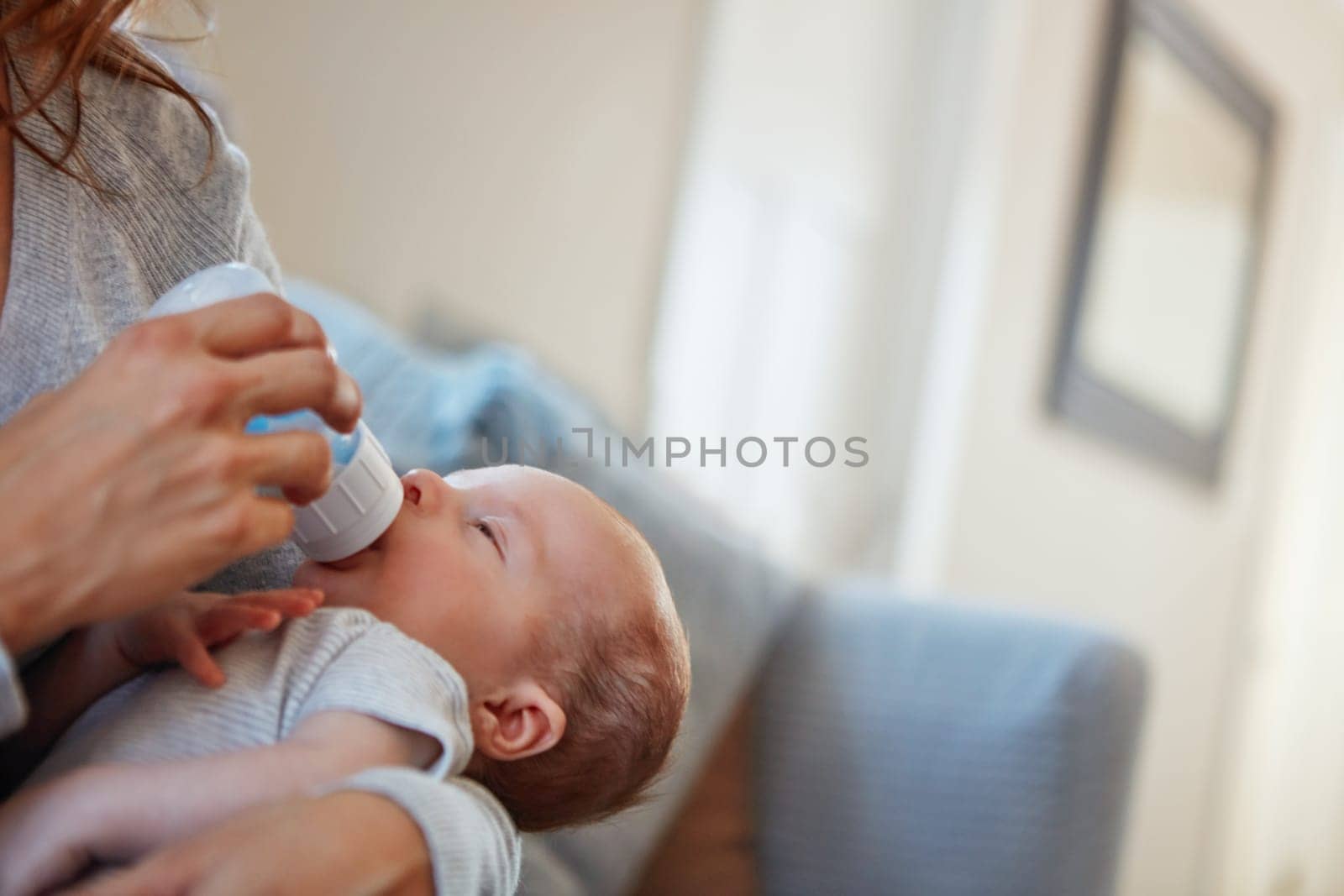 Falling asleep after hes filled his tummy. a mother feeding her newborn baby