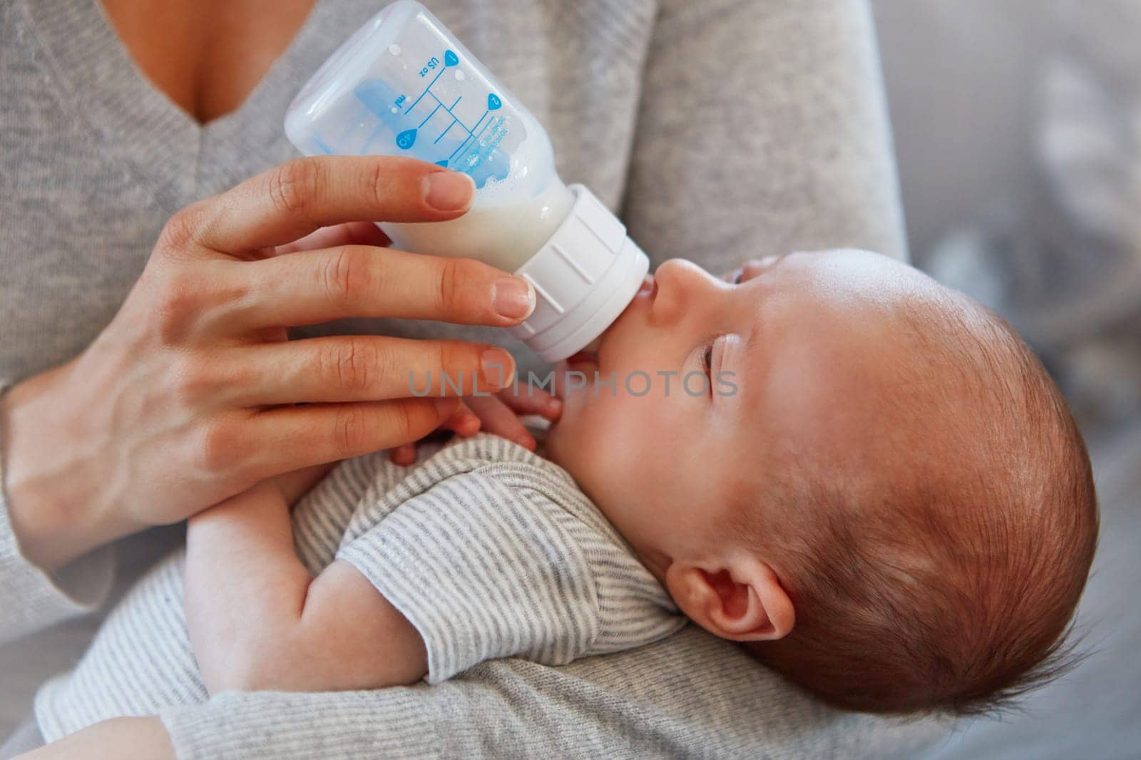 Hes so content. Closeup shot of a mother feeding her newborn baby