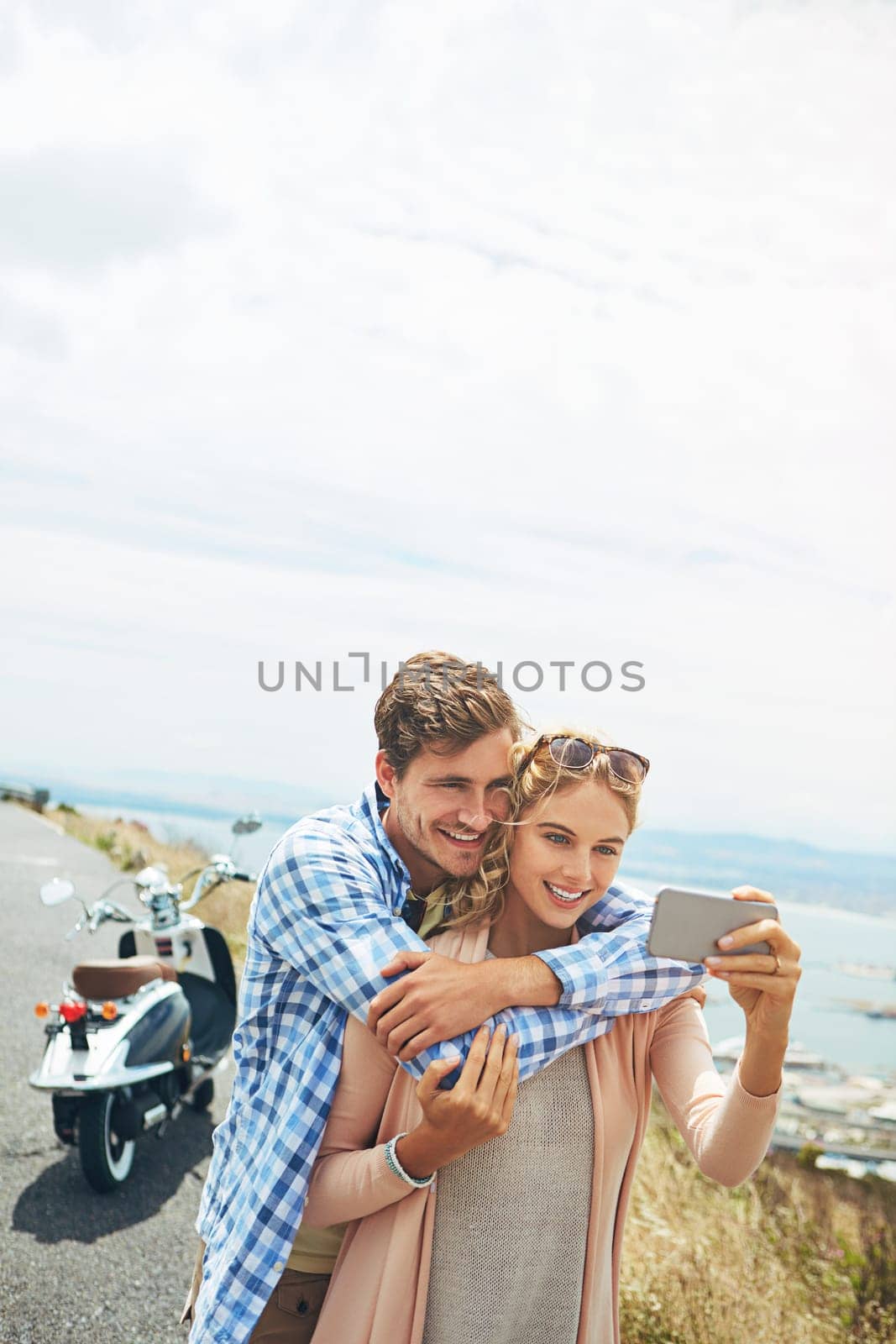 Love is beautiful capture every moment. a couple taking a selfie outdoors. by YuriArcurs