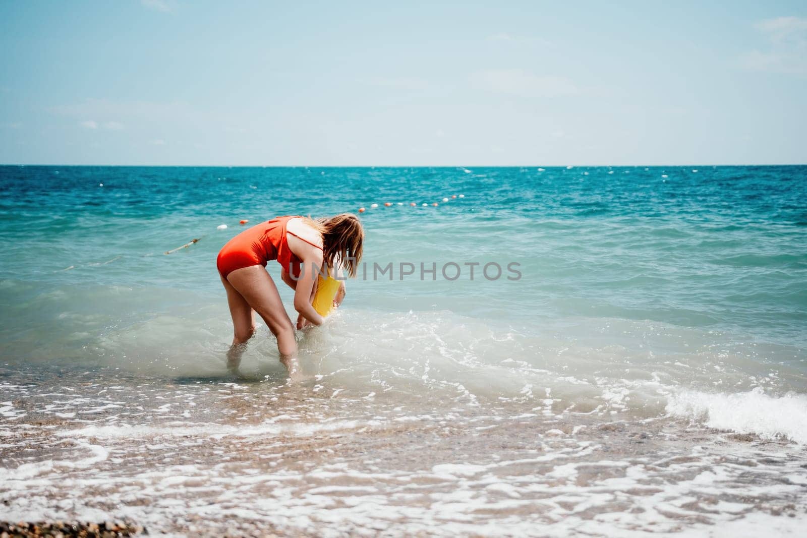 Happy loving family mother and daughter having fun together on the beach. Mum playing with her kid in holiday vacation next to the ocean - Family lifestyle and love concept by panophotograph