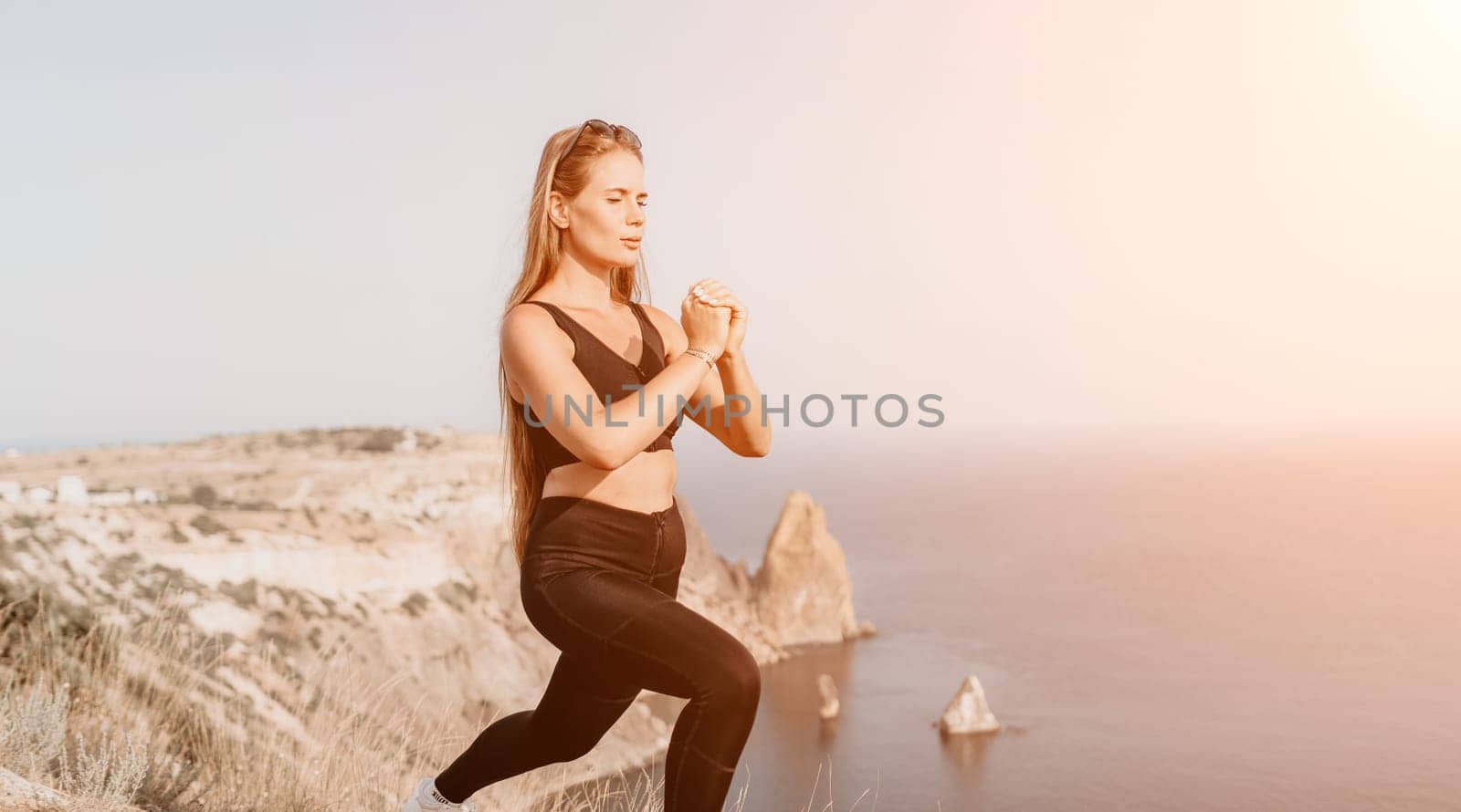 Fitness woman sea. Outdoor workout on yoga mat in park near to ocean beach. Female fitness pilates yoga routine concept. Healthy lifestyle. Happy fit woman exercising with rubber band in park. by panophotograph