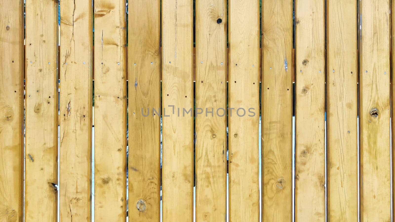 Fence made of wooden slats as Location, Background, texture, copy of space, frame. Abstract natural graphic resource